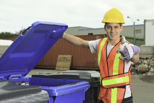 Builders using a skip on a construction project